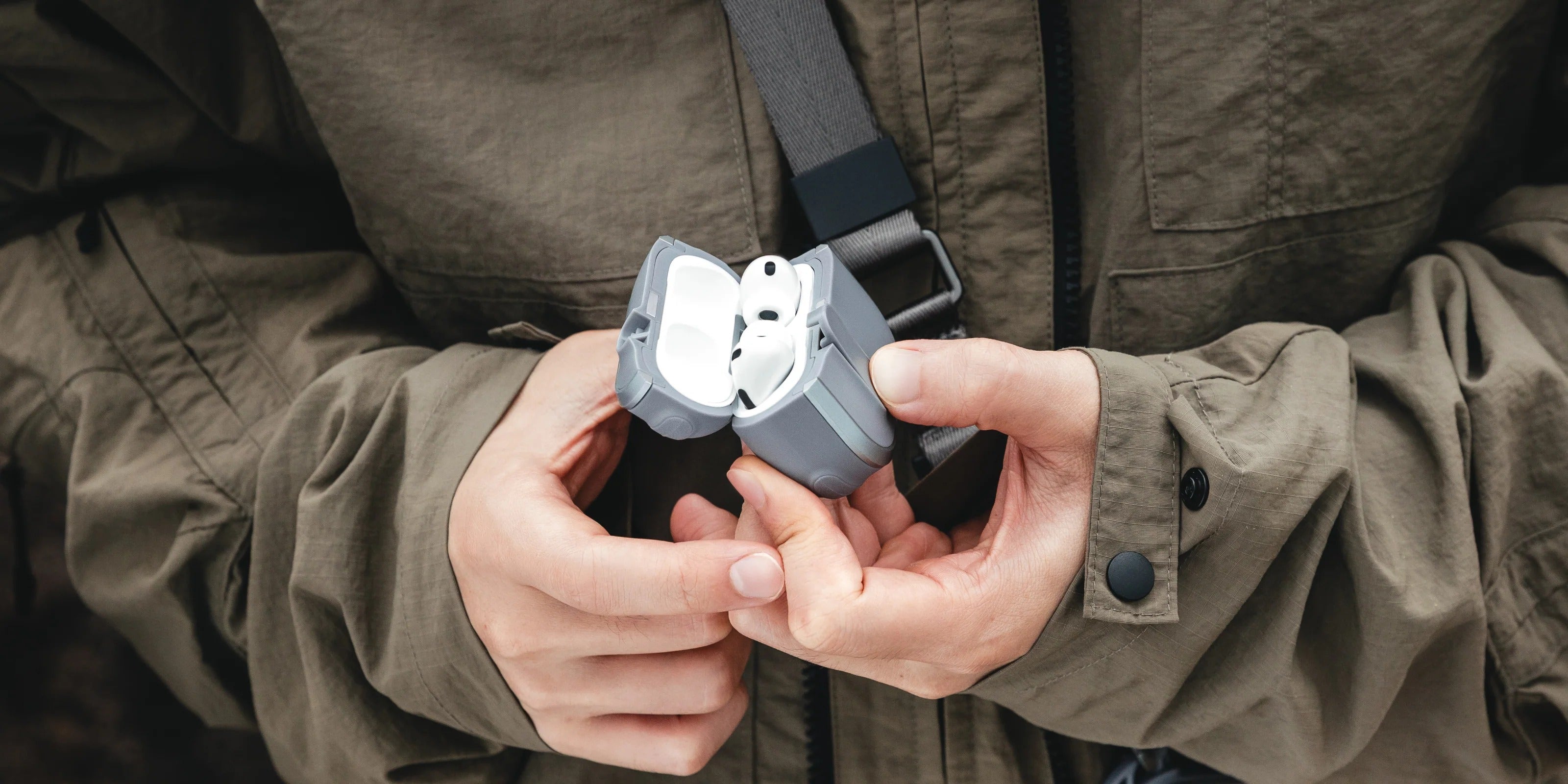 MAGEASY Odyssey rugged AirPods Pro 3 case opened in hand to show quick access to AirPods