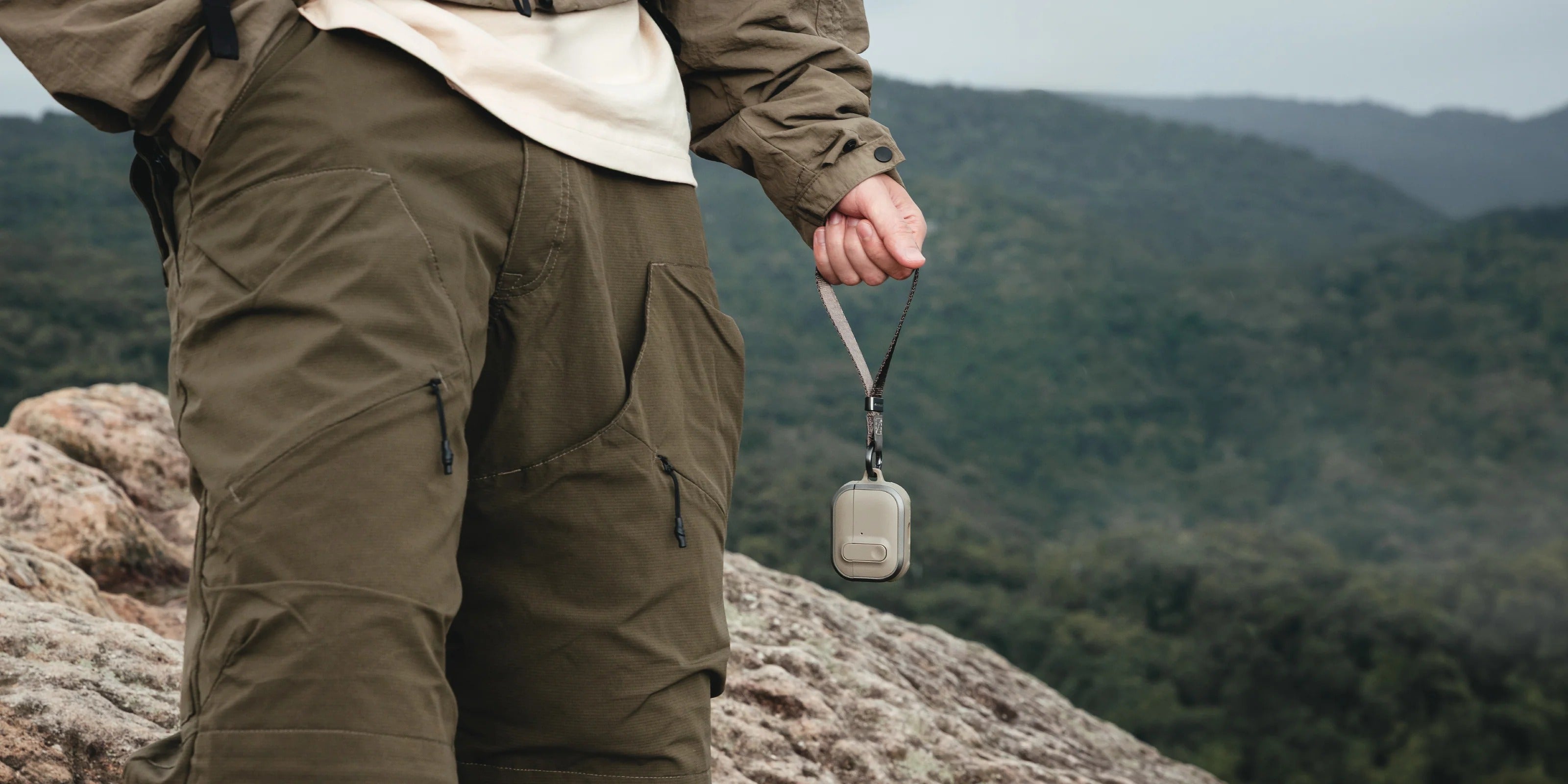 MAGEASY Odyssey AirPods Pro 3 case color lineup with strap and carabiner on rock surface